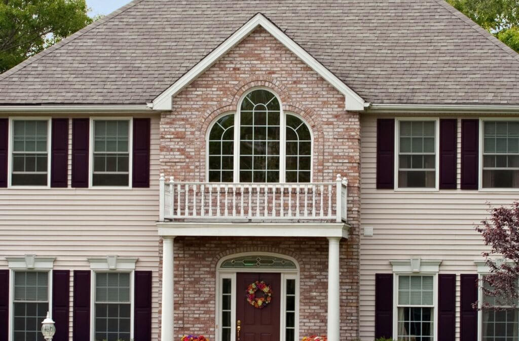 Closeup of custom window world window on second story of home.